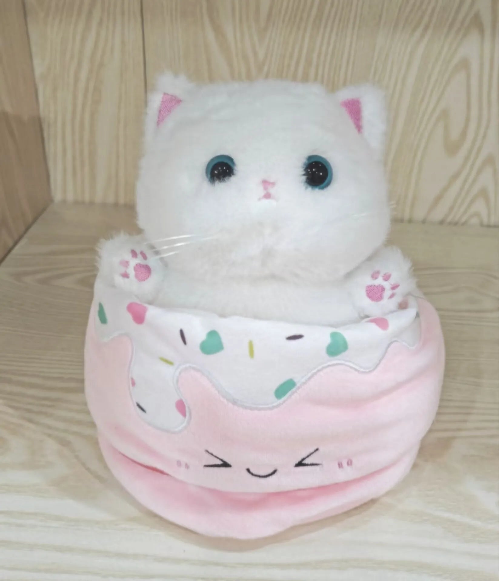 Adorable Plush Cat in Striped Cupcake Bed - Image 4