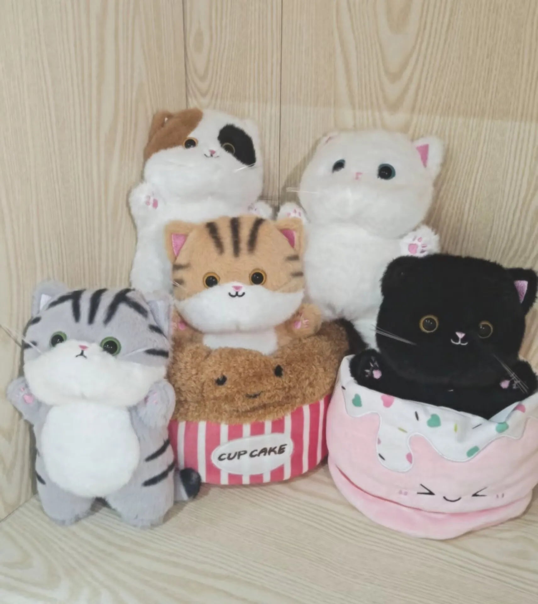 Adorable Plush Cat in Striped Cupcake Bed - Image 3