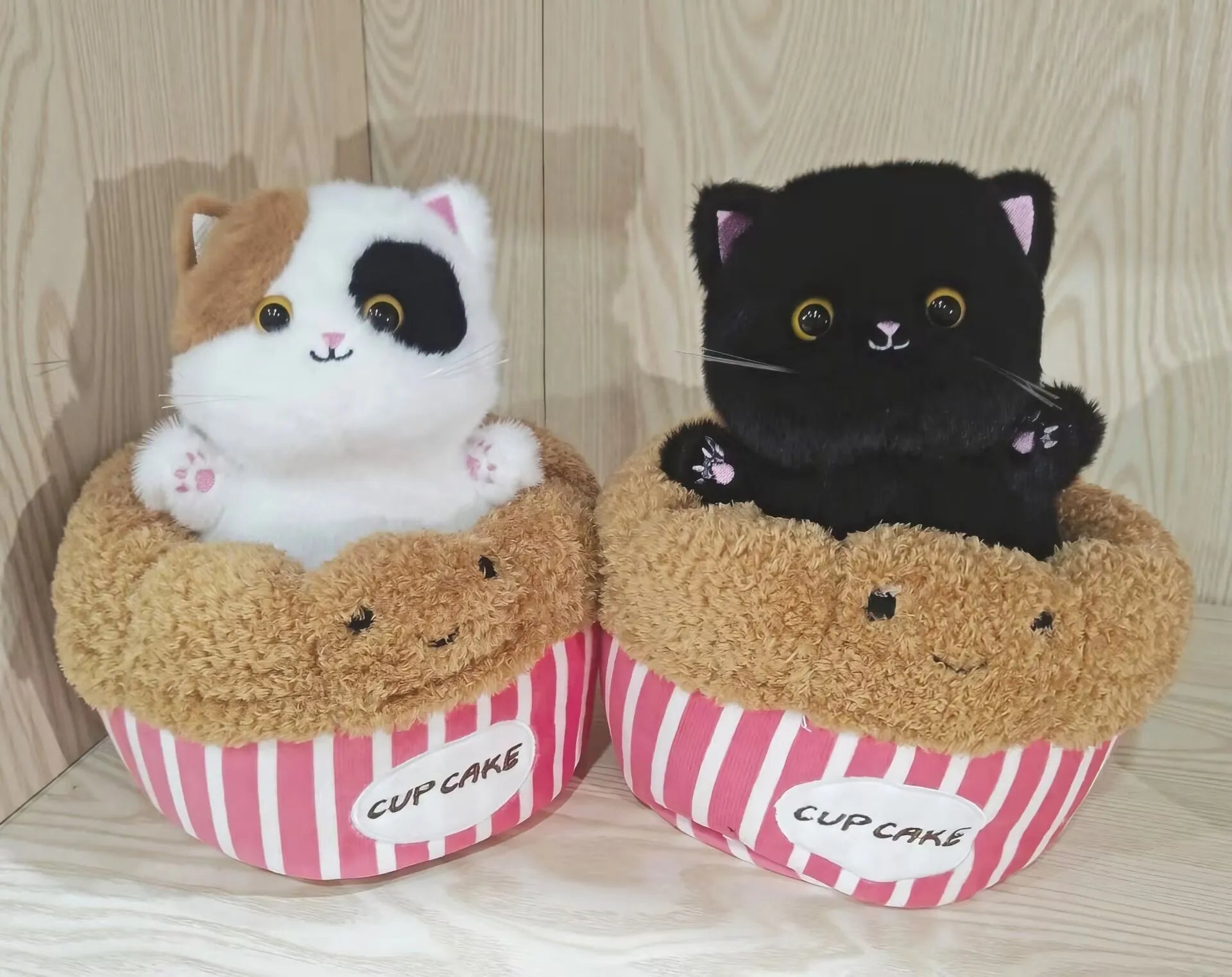 Adorable Plush Cat in Striped Cupcake Bed