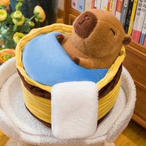 Sleeping Capybara Plush with Blue Blanket in Bed